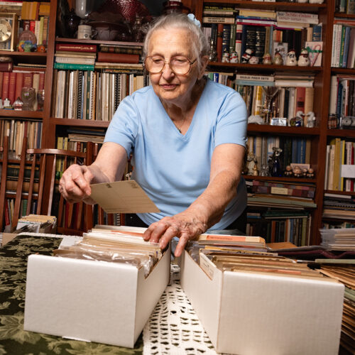 Betty Davis, postcard collector and TCNJ alumna at home with her extensive collection in Wrightstown Township, PA.